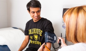 Student having blood pressure read by nurse Student having blood pressure read by nurse
